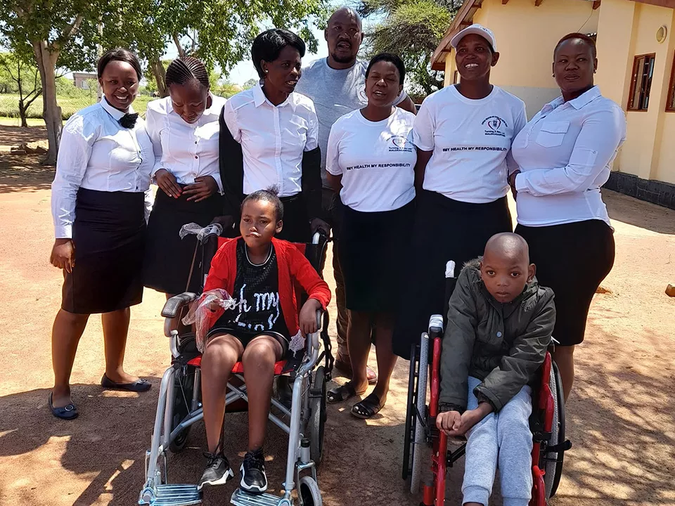 Children in donated wheelchairs